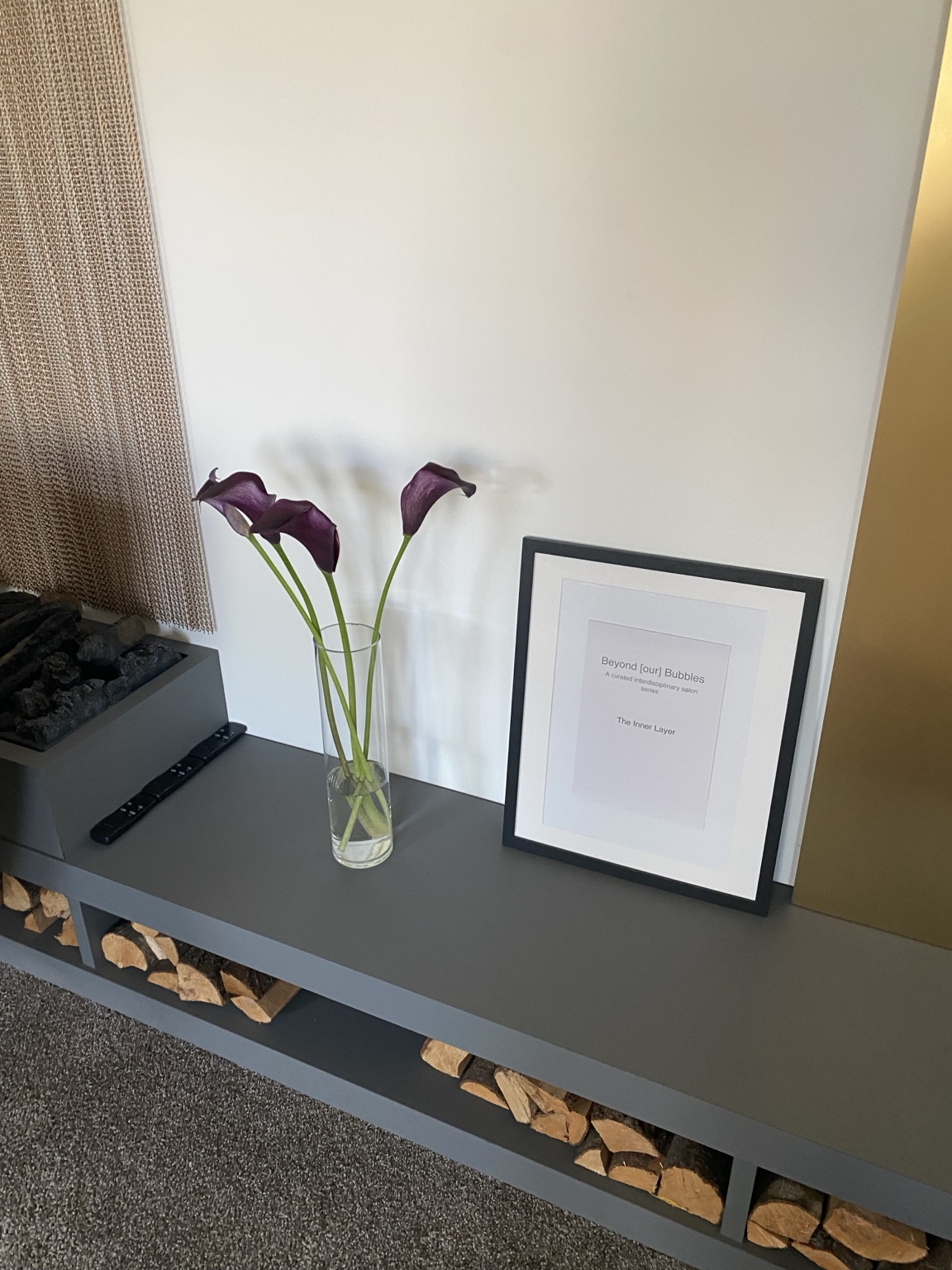 Flowers and a framed invitation to The Inner Layer Summer Salon